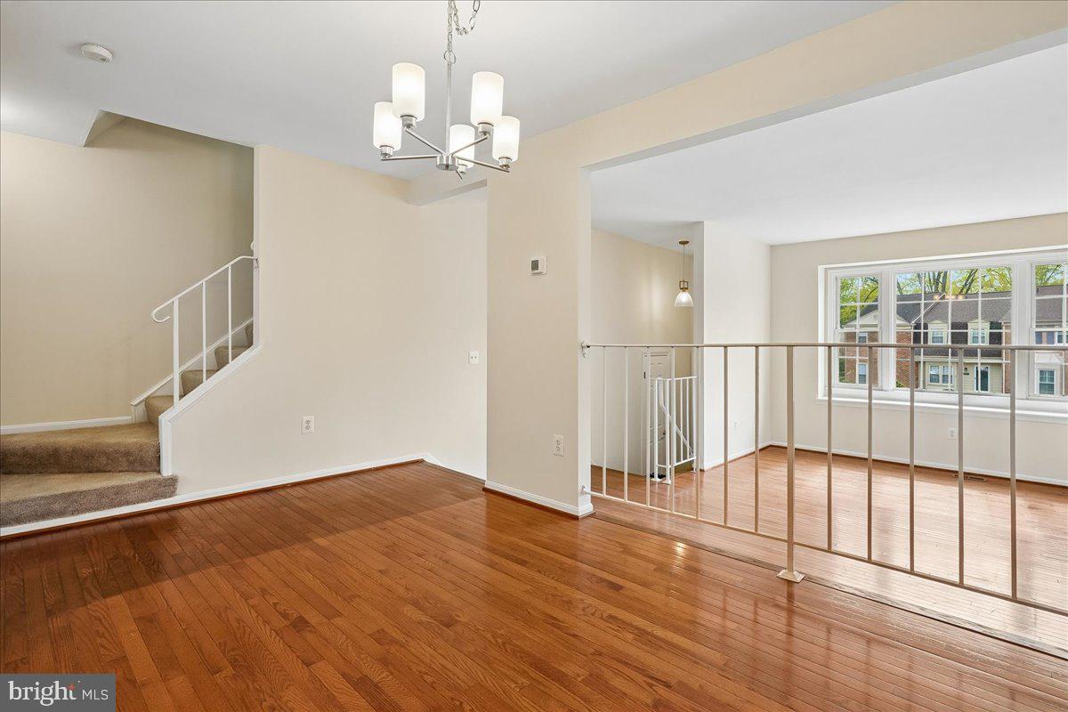 9752 High Water Court Burke, VA 22015 - Photo 4 of 25 a view of an empty room with wooden floor