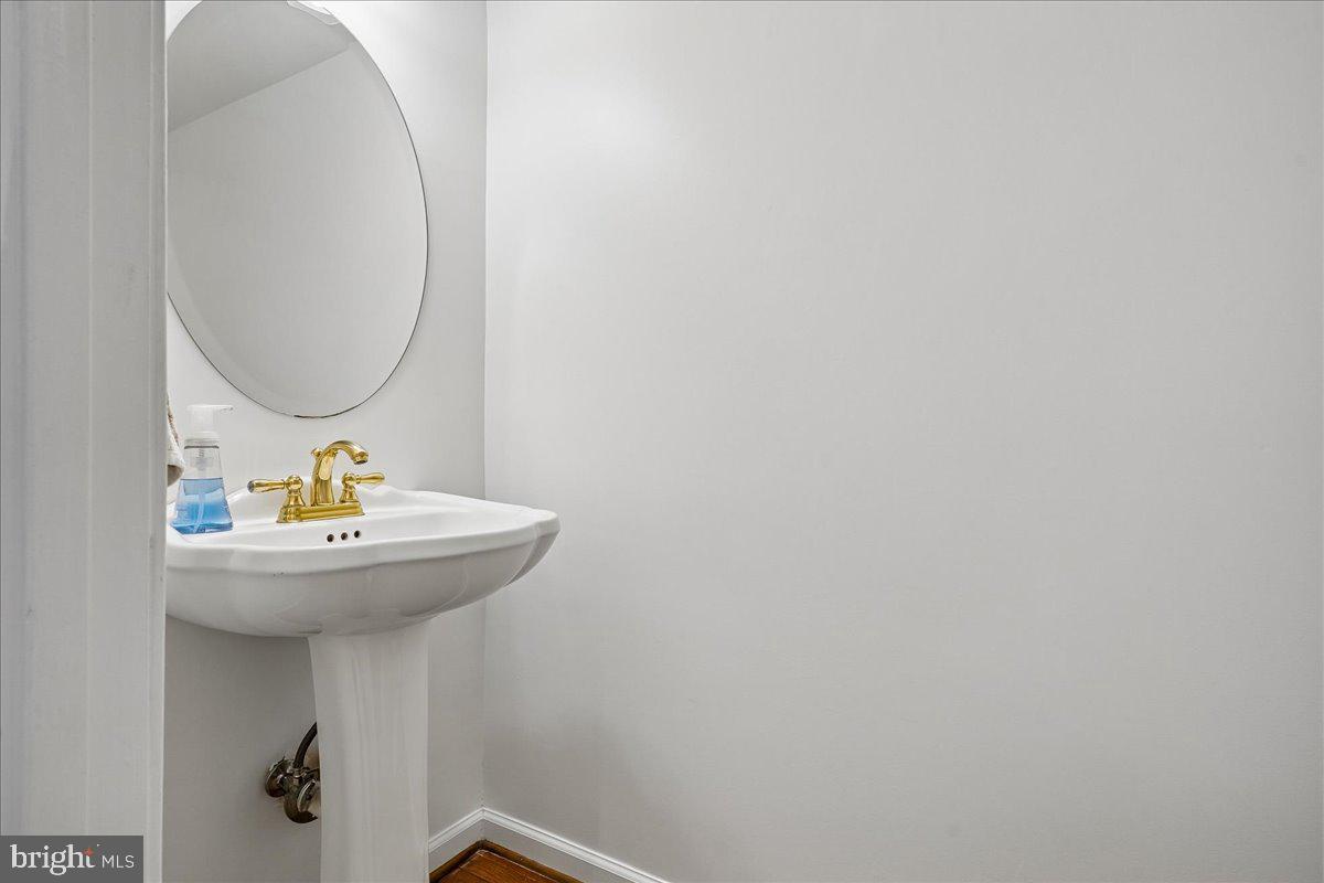 9752 High Water Court Burke, VA 22015 - Photo 7 of 25 a bathroom with a sink and mirror