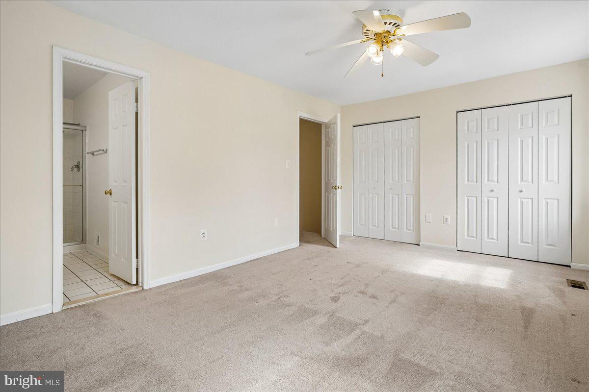 9752 High Water Court Burke, VA 22015 - Photo 8 of 25 an empty room with closet and a chandelier fan