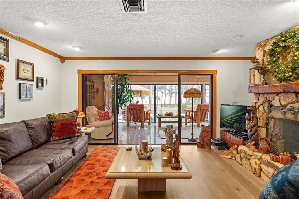 4345 Corley Island Road Leesburg, FL 34748 - Photo 20 of 73 a living room with furniture and a floor to ceiling window