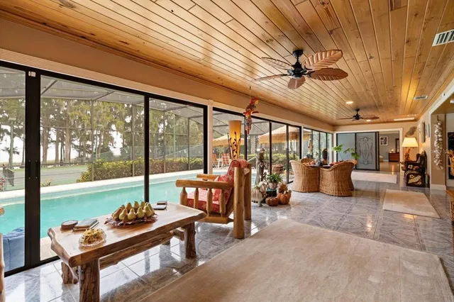 a swimming pool with outdoor next to a yard