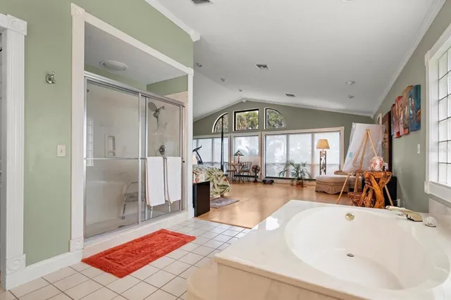 a view of a house with wooden stairs and a small yard