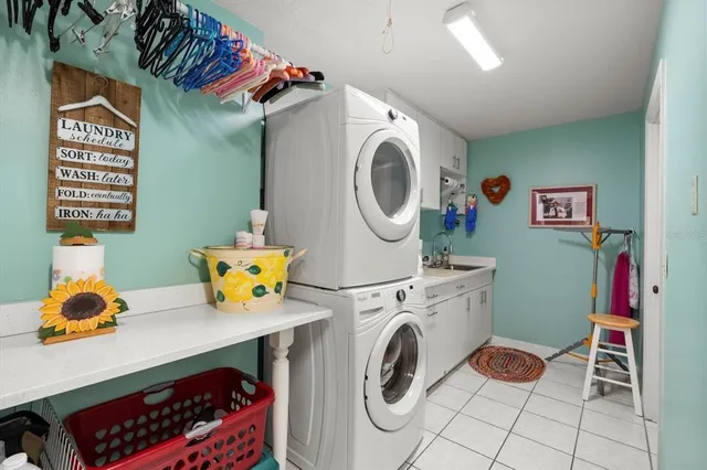 a kitchen with granite countertop a refrigerator sink and cabinets