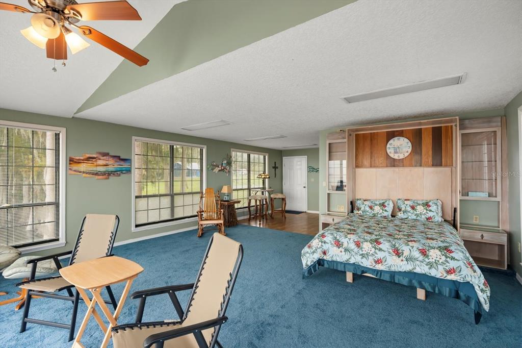 4345 Corley Island Road Leesburg, FL 34748 - Photo 49 of 73 a bedroom with furniture and a window