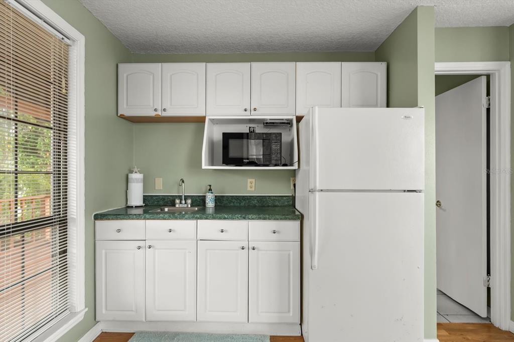 4345 Corley Island Road Leesburg, FL 34748 - Photo 53 of 73 a kitchen with granite countertop a refrigerator sink and cabinets