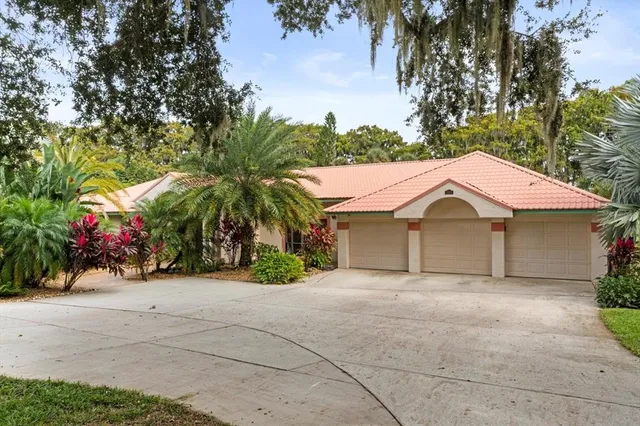 a view of a house with a yard and tree