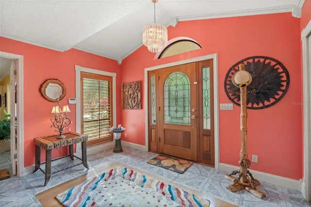 a bedroom with furniture and large windows