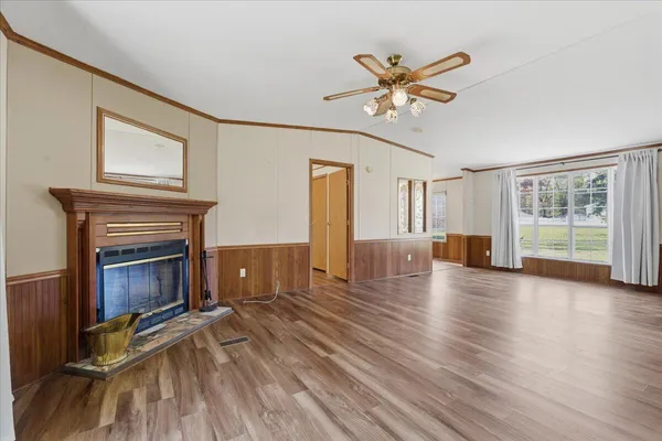 a view of a livingroom with a fireplace and window