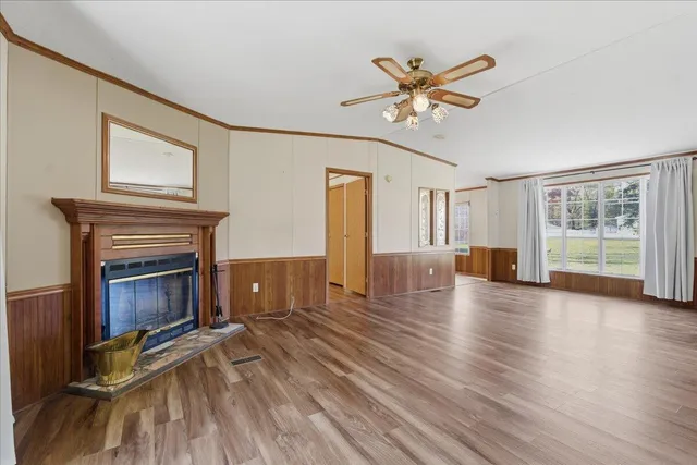 a view of a livingroom with a fireplace and window