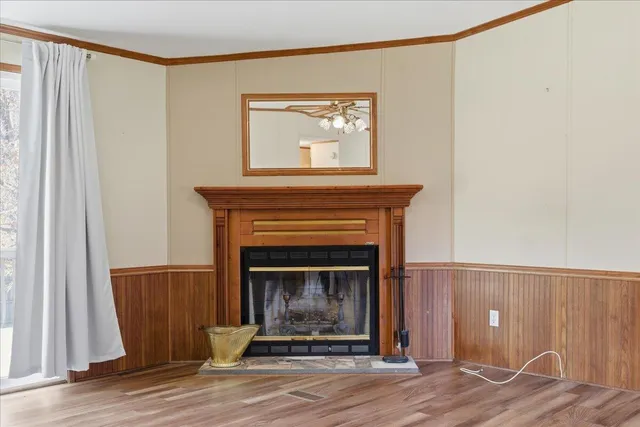 a living room with a fireplace and a wooden floor