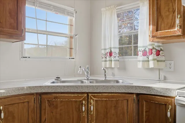 a kitchen with granite countertop a sink and a window