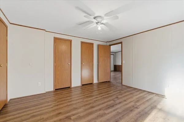 a view of an empty room with wooden floor