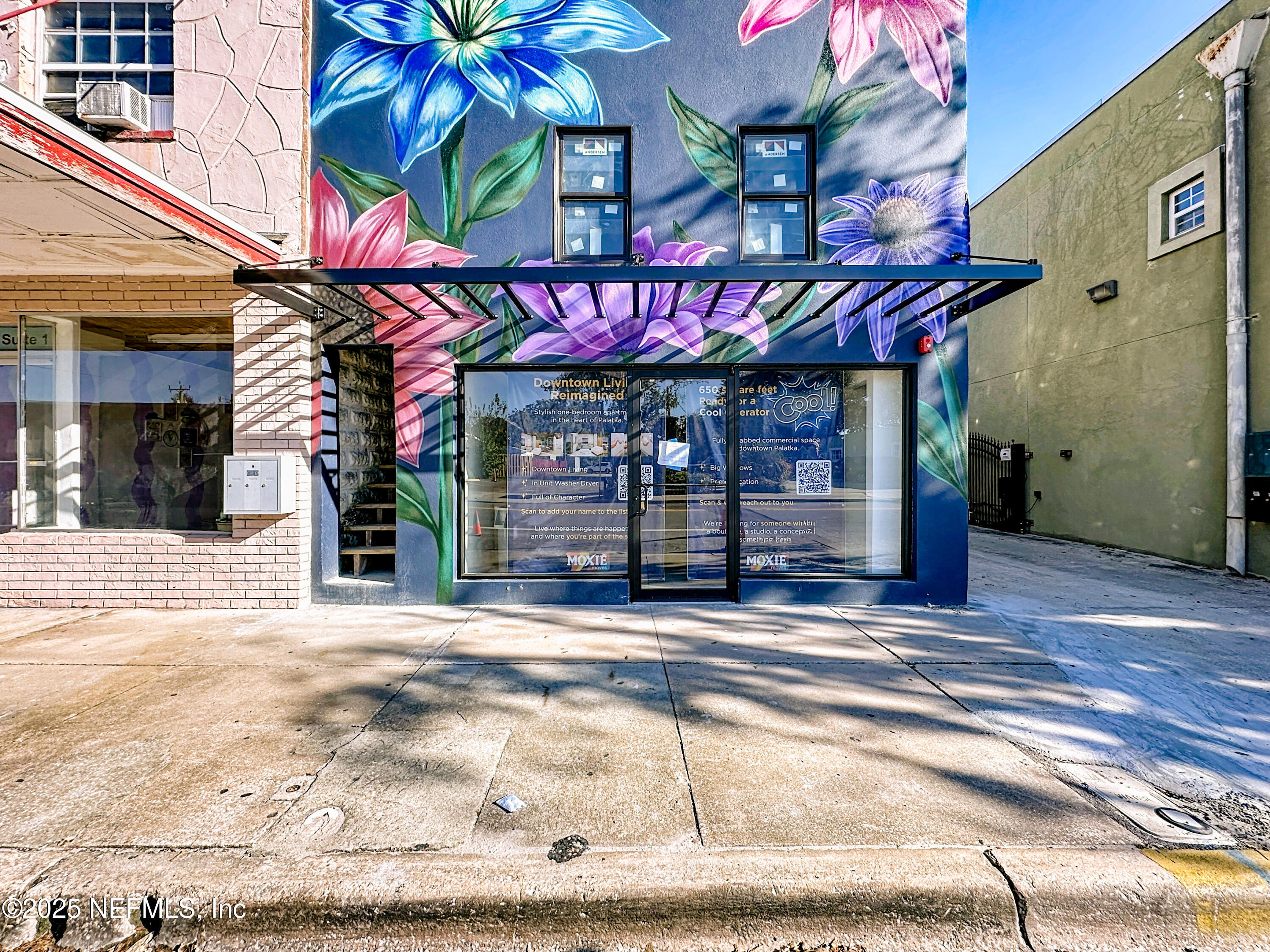 912 St Johns Avenue, Unit 101 Palatka, FL 32177 - Photo 1 of 33 a view of a cafe with a table and chairs under an umbrella