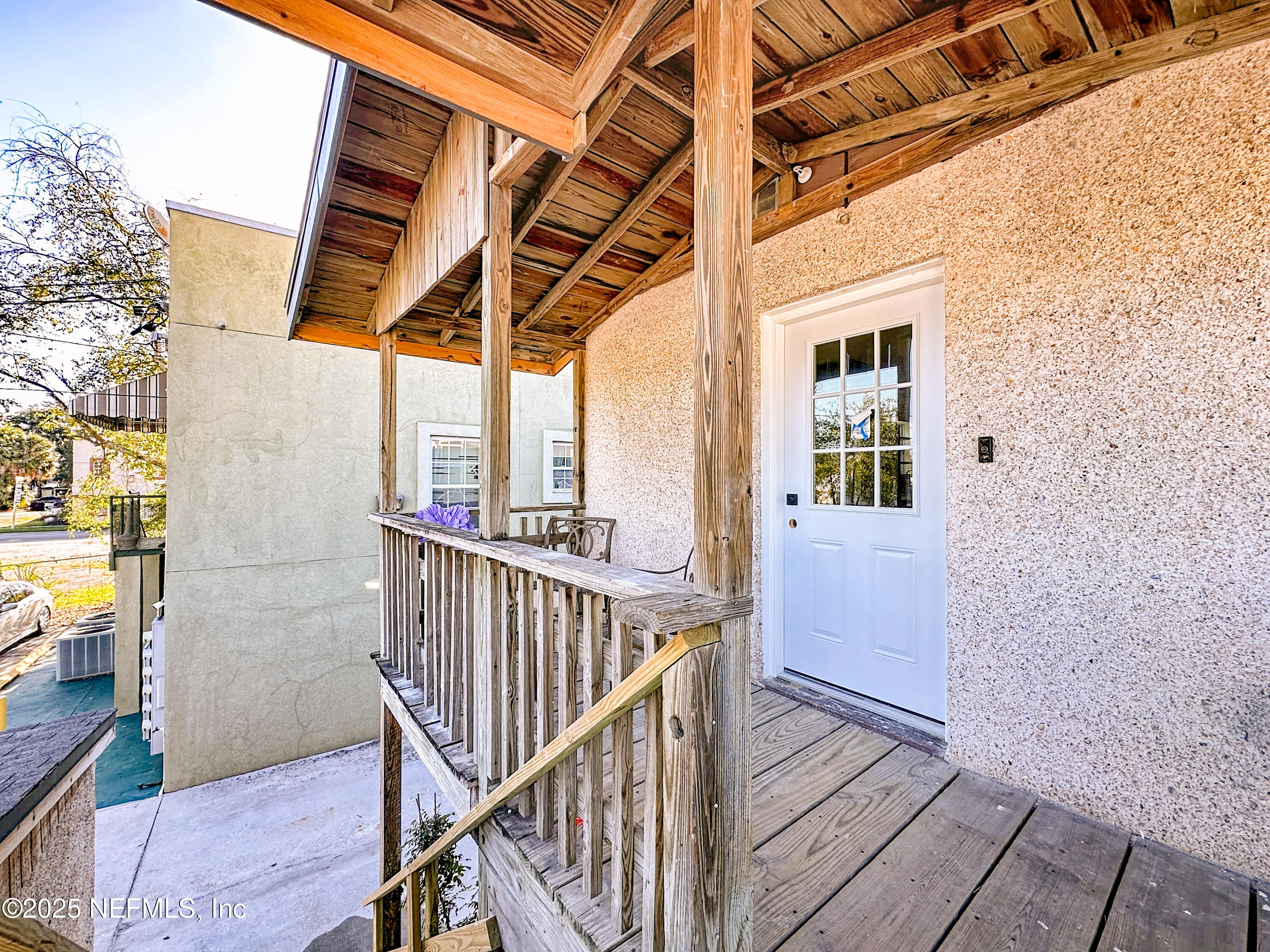 912 St Johns Avenue, Unit 101 Palatka, FL 32177 - Photo 12 of 33 a view of balcony with wooden floor and fence