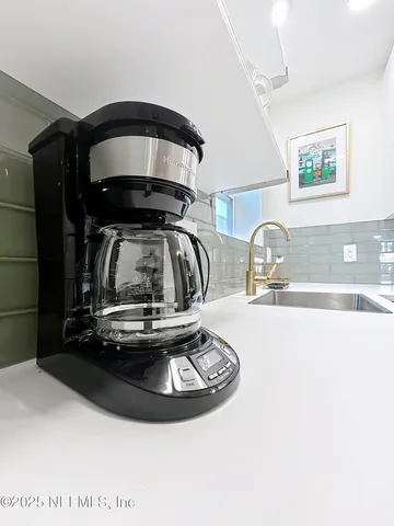 a living room with furniture and kitchen