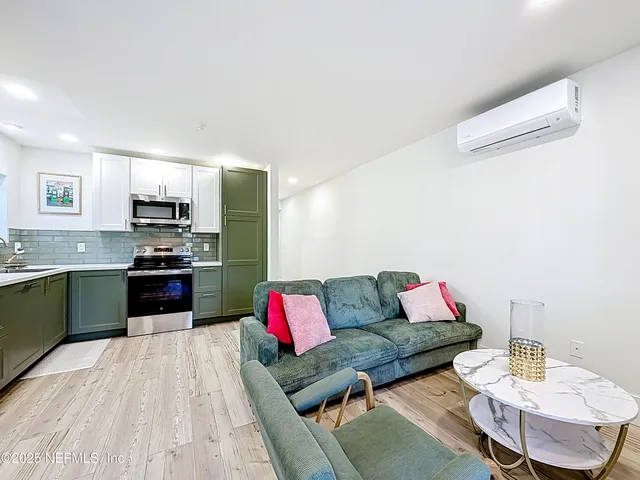 a kitchen with granite countertop a refrigerator and a sink
