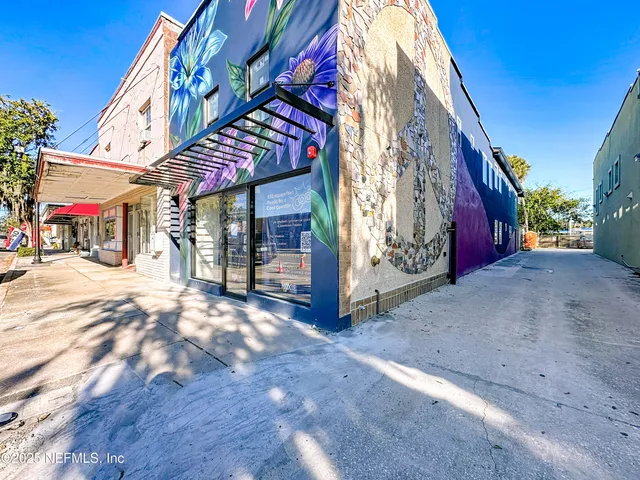 a view of a street with shops