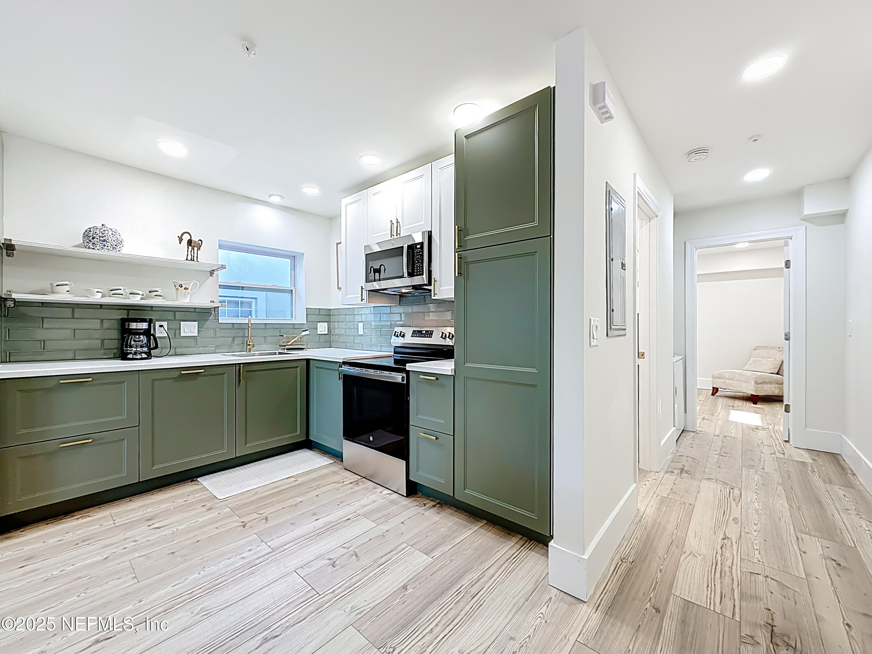 912 St Johns Avenue, Unit 101 Palatka, FL 32177 - Photo 23 of 33 a kitchen with granite countertop a refrigerator and a sink