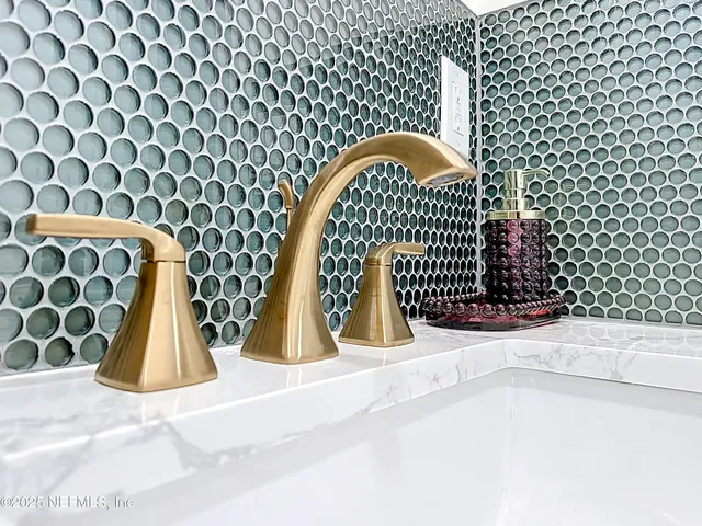 a spacious bedroom with a large bed and a chandelier