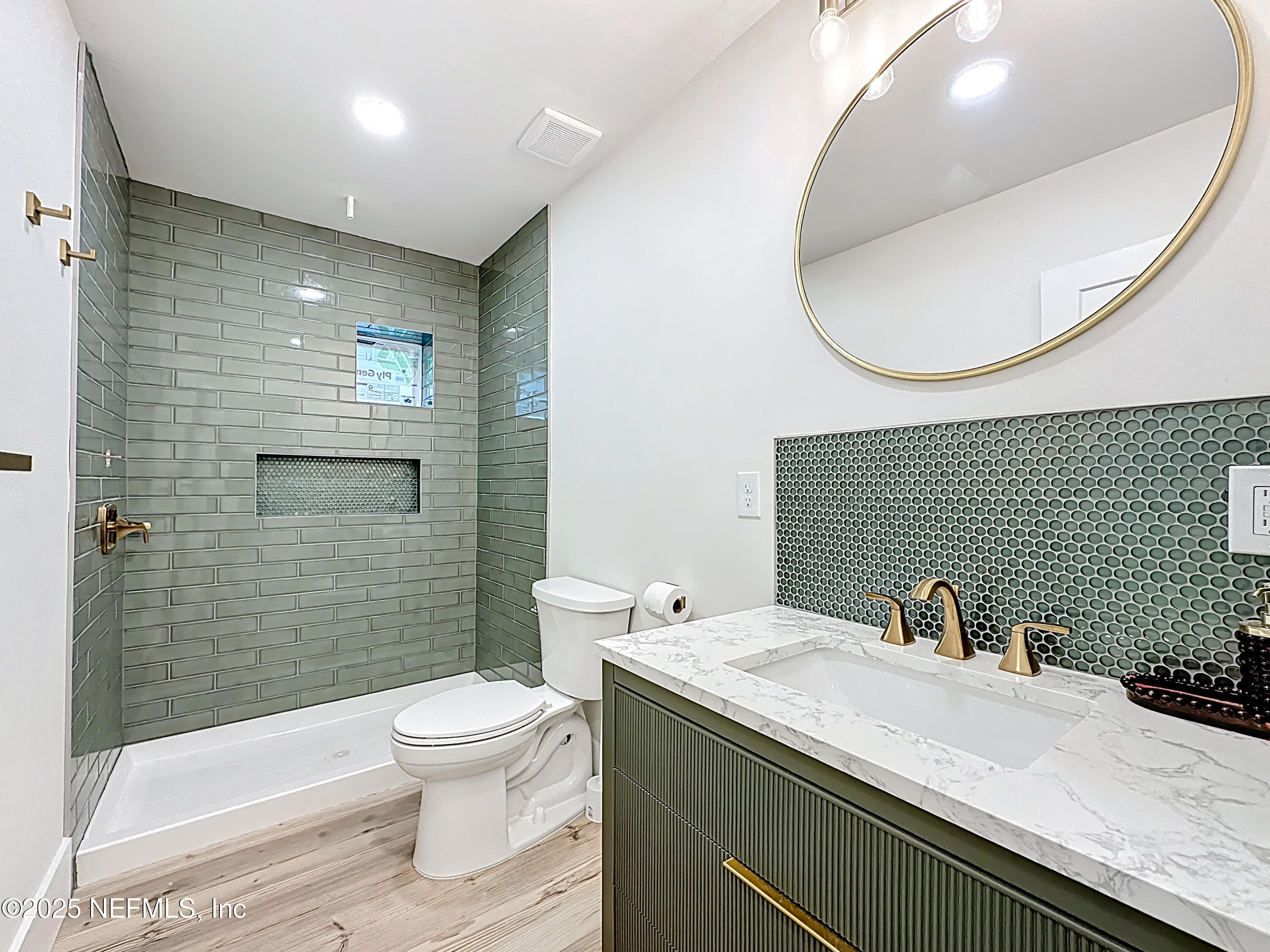 912 St Johns Avenue, Unit 101 Palatka, FL 32177 - Photo 28 of 33 a bathroom with a sink a toilet and a mirror