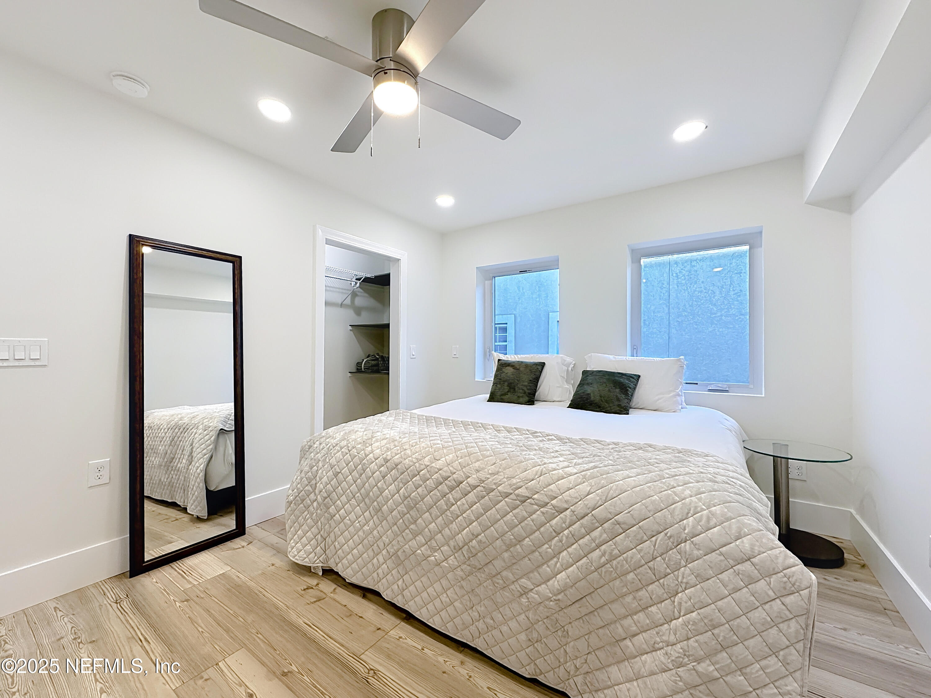 912 St Johns Avenue, Unit 101 Palatka, FL 32177 - Photo 30 of 33 a spacious bedroom with a large bed and a chandelier