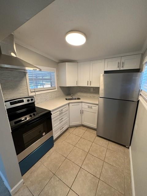 3205 Northeast 9th Street, Unit 4 Pompano Beach, FL 33062 - Photo 1 of 11 a kitchen with a stove a refrigerator and a sink