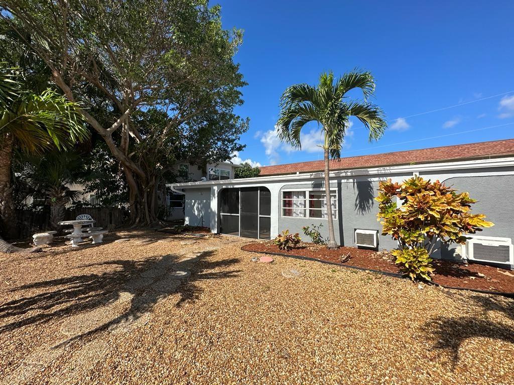 3205 Northeast 9th Street, Unit 4 Pompano Beach, FL 33062 - Photo 10 of 11 a front view of a house with a patio