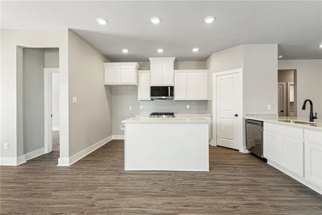 a kitchen with a white stove top oven and refrigerator