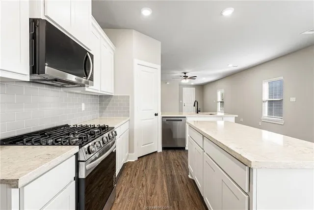 a kitchen with a sink stove and microwave