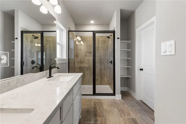 a spacious bathroom with a shower and a sink
