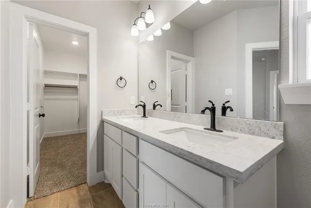 a bathroom with a sink vanity and a mirror