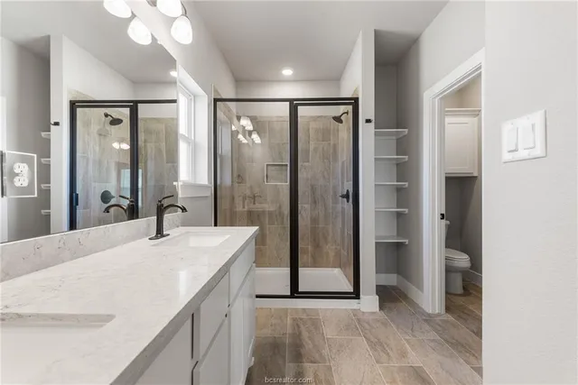 a spacious bathroom with a shower and a sink