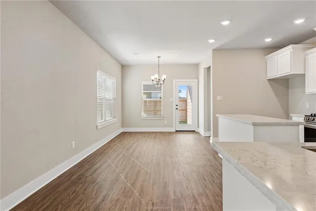 a view of a kitchen with wooden floor and a sink