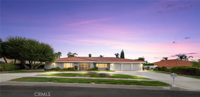 a view of a house with a yard and a street