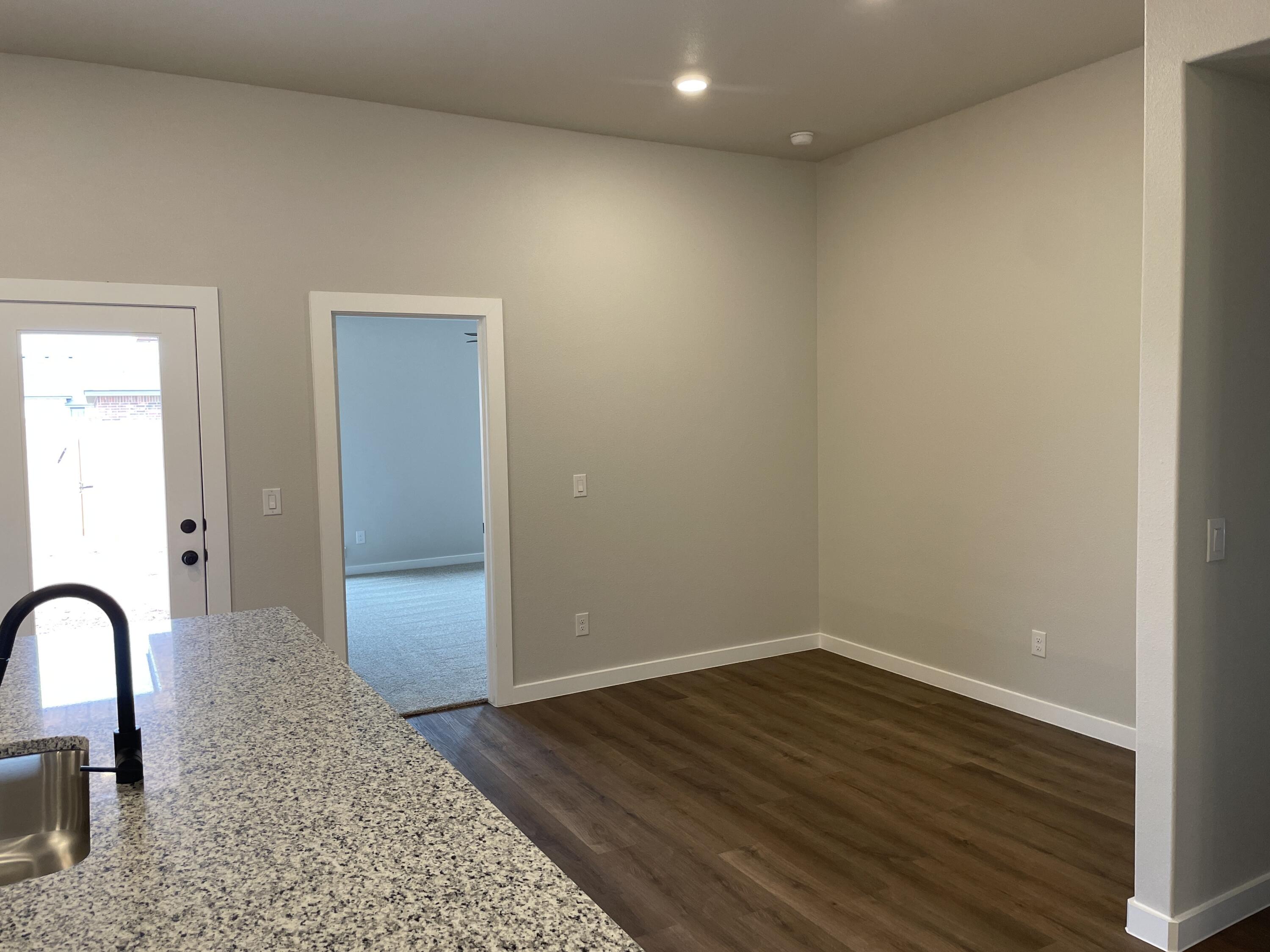 7450 29th Street Lubbock, TX 79407 - Photo 14 of 32 a view of room with wooden floor