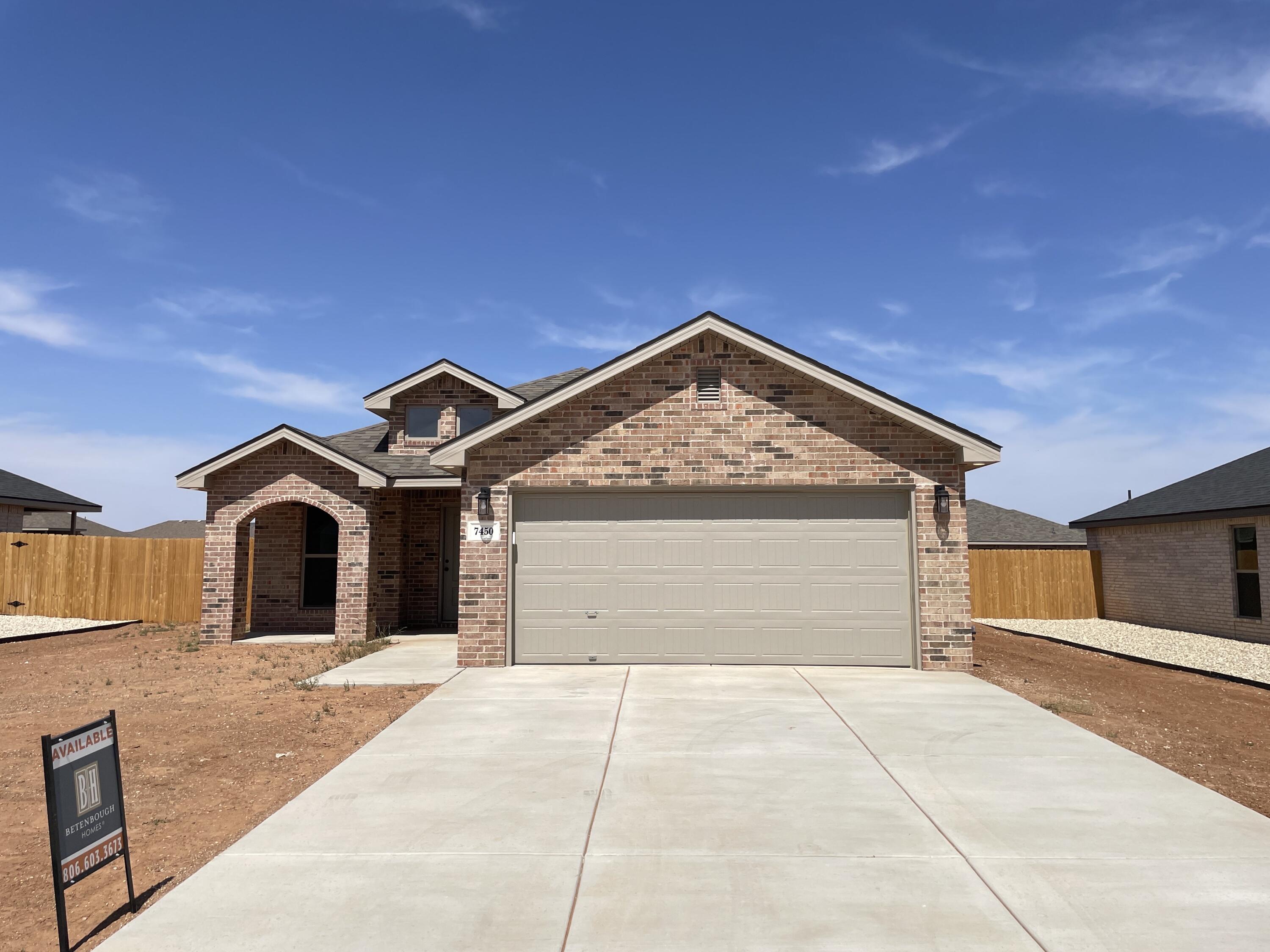 7450 29th Street Lubbock, TX 79407 - Photo 2 of 32 a front view of a house with a yard and garage