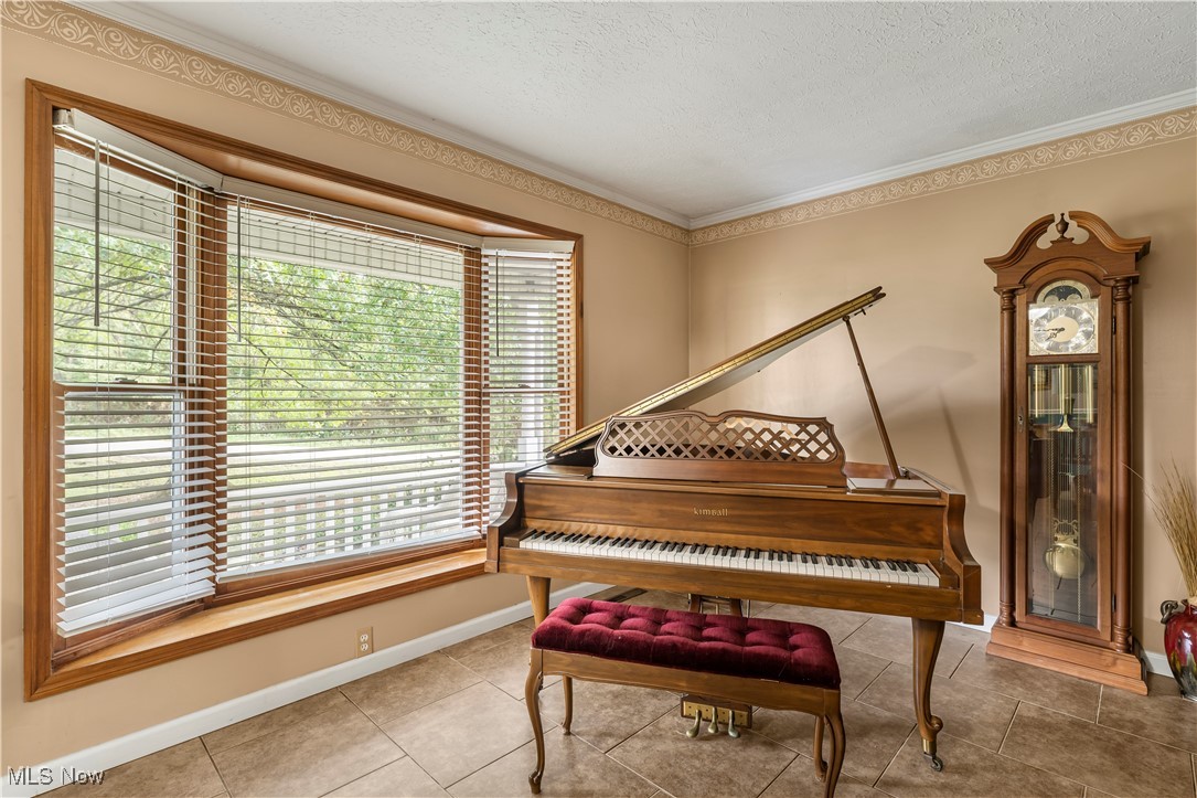 155 Ridgewood Boulevard Belpre, OH 45714 - Photo 9 of 49 Sitting room with ornamental molding, tile patterned flooring, and a textured ceiling