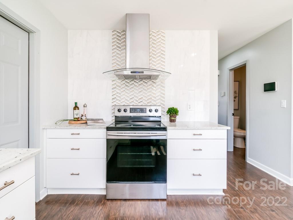 5510 Rogers Road Indian Trail, NC 28079 - Photo 15 of 35 a kitchen with a stove oven and white cabinets