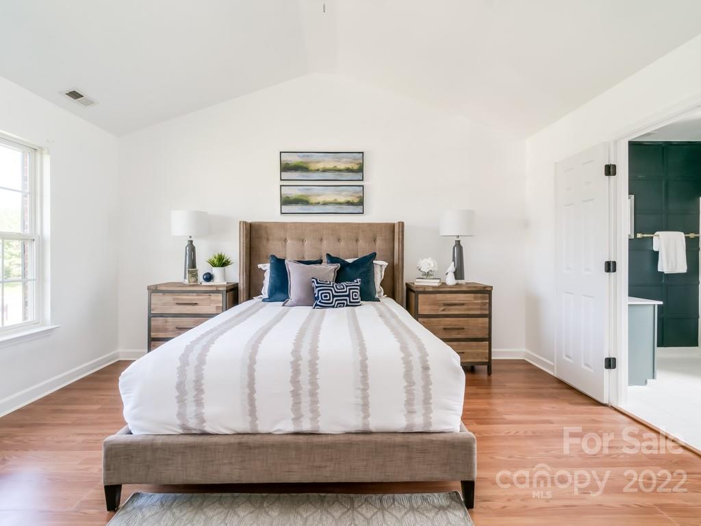 5510 Rogers Road Indian Trail, NC 28079 - Photo 21 of 35 a bedroom with a bed and wooden floor
