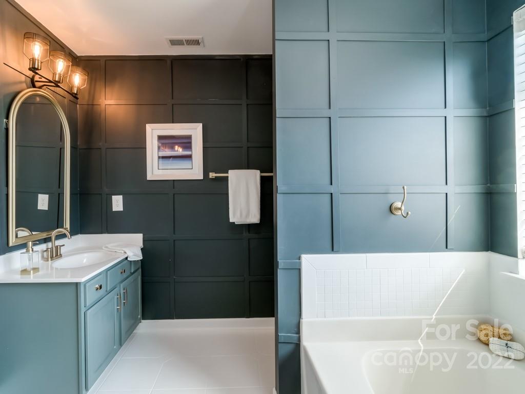 5510 Rogers Road Indian Trail, NC 28079 - Photo 23 of 35 a bathroom with a bathtub sink and mirror