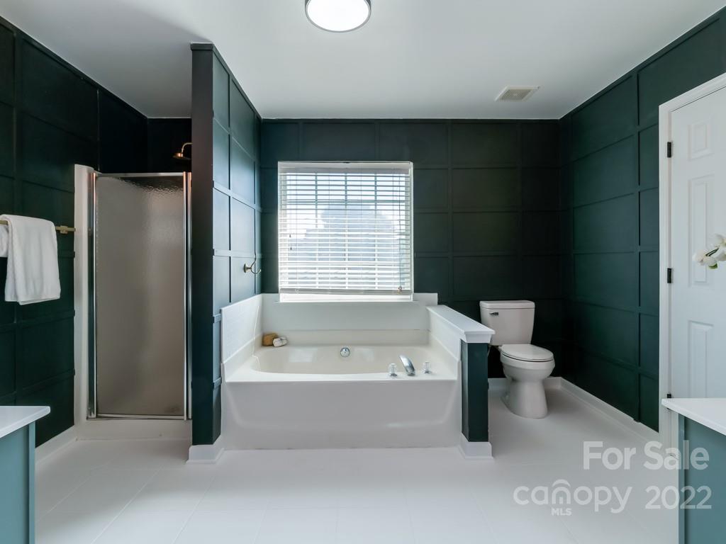 5510 Rogers Road Indian Trail, NC 28079 - Photo 24 of 35 a bathroom with a bathtub and a shower