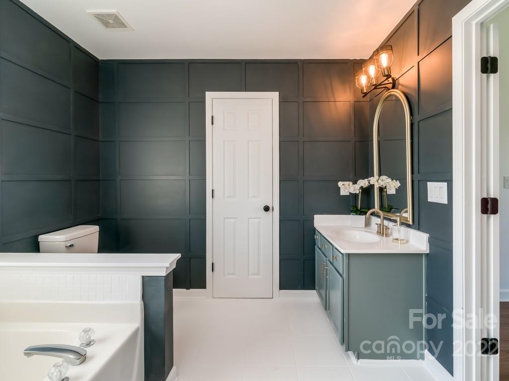 5510 Rogers Road Indian Trail, NC 28079 - Photo 25 of 35 a bathroom with a sink and a mirror
