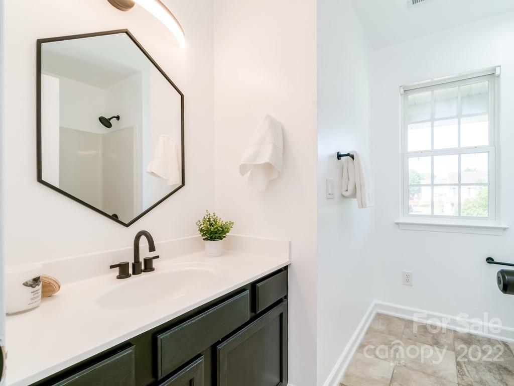 5510 Rogers Road Indian Trail, NC 28079 - Photo 30 of 35 a bathroom with a sink and a mirror