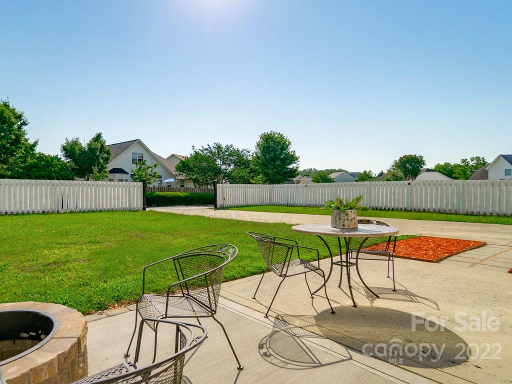 5510 Rogers Road Indian Trail, NC 28079 - Photo 34 of 35 a view of swimming pool with lawn chairs and wooden fence