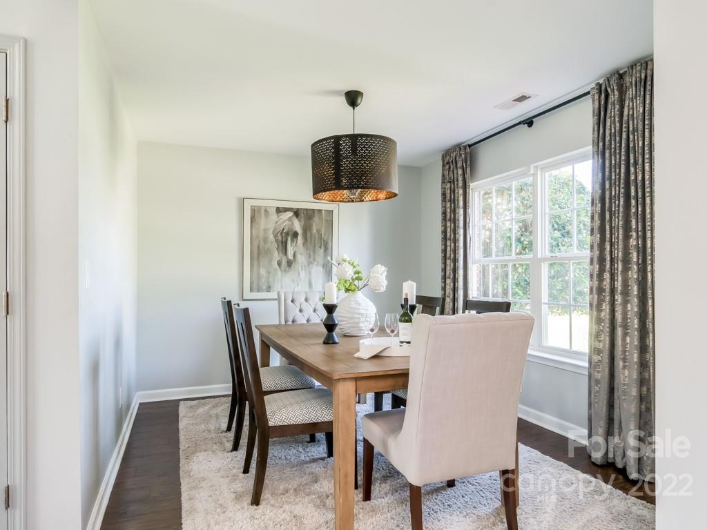 5510 Rogers Road Indian Trail, NC 28079 - Photo 4 of 35 a dining room with furniture a chandelier and wooden floor