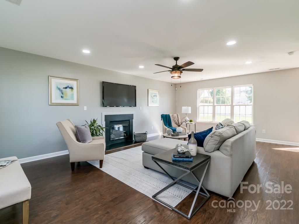 5510 Rogers Road Indian Trail, NC 28079 - Photo 5 of 35 a living room with furniture a fireplace and a flat screen tv