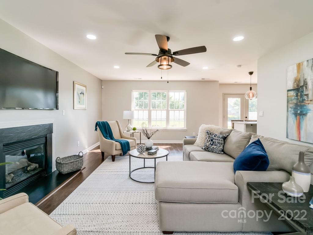 5510 Rogers Road Indian Trail, NC 28079 - Photo 6 of 35 a living room with furniture a flat screen tv and a fireplace