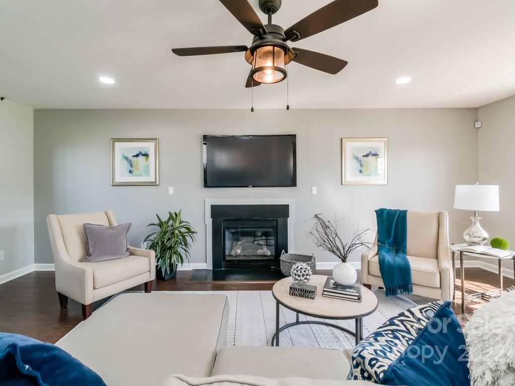 5510 Rogers Road Indian Trail, NC 28079 - Photo 7 of 35 a living room with furniture a fireplace and a flat screen tv