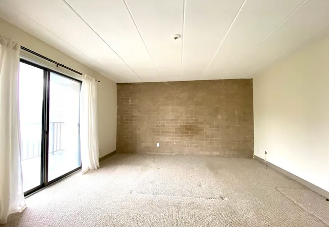 a bedroom with a large bed and wooden floor
