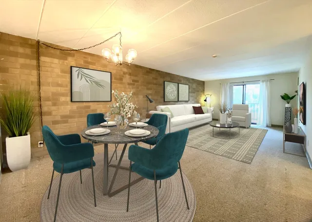 a living room with furniture and a painting on the wall